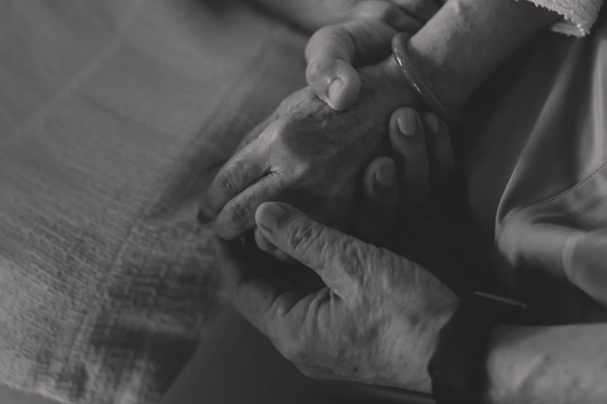 Two hands gently holding each other